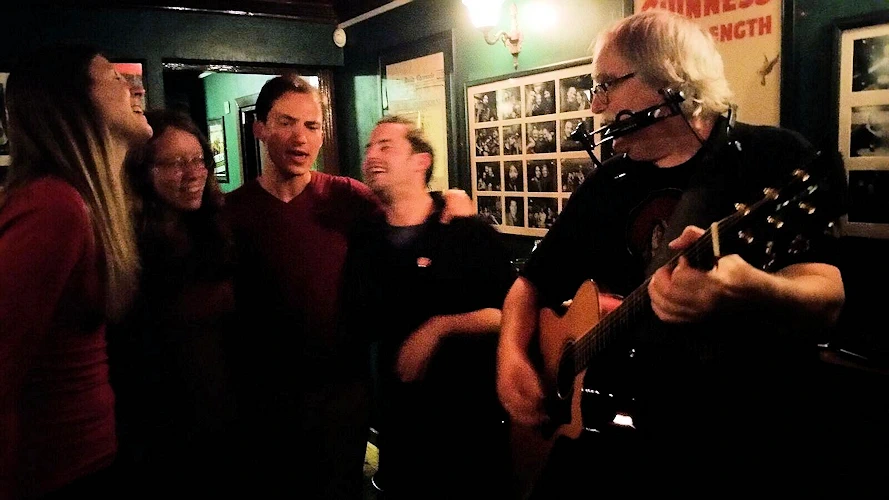 Douglas Lee Saum performing in an Irish pub