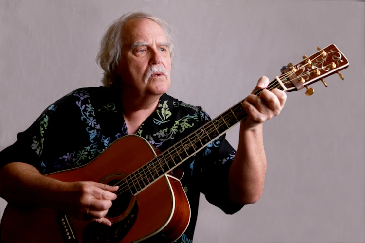 Douglas Lee Saum playing guitar